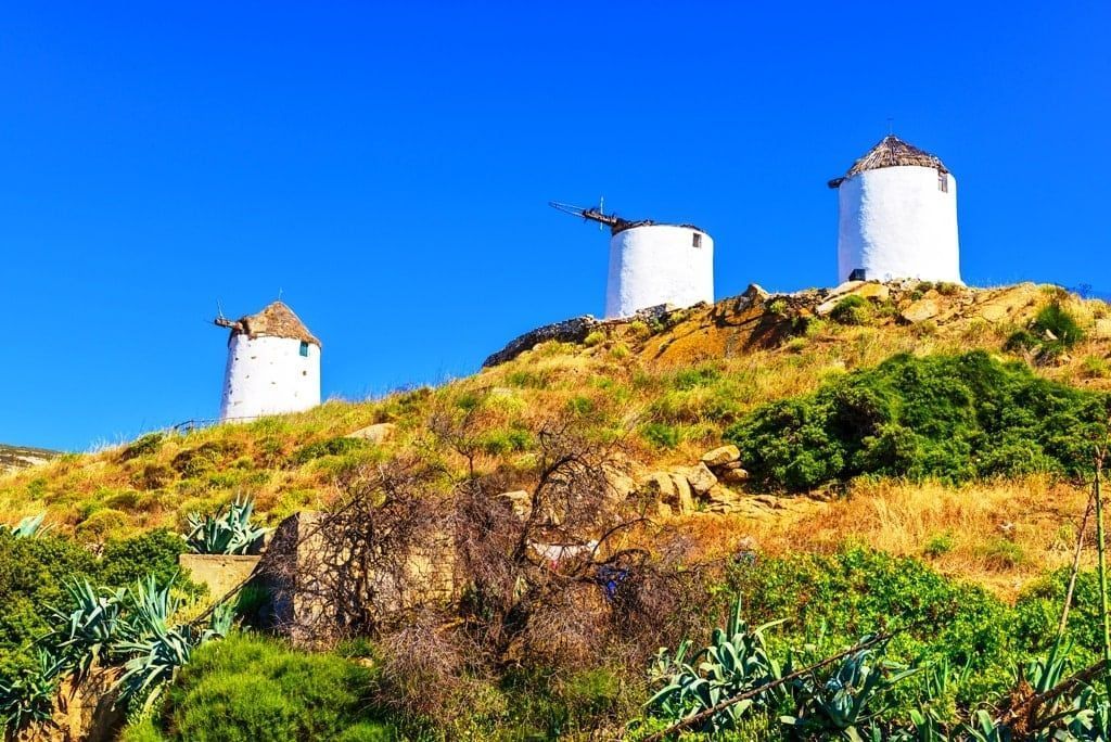 Three-traditional-windmills-in-Tripodes-also-known-as-Vivlos-one-of-the-largest-and-most-picturesque-villages-in-southwestern-Naxos.-Cyclades-Islands.-Greece.-min